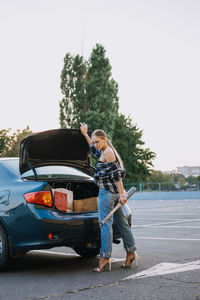 Girl power, feminism, women self-defense. portrait of woman with baseball bat on parking 