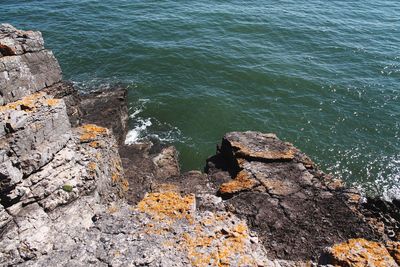 High angle view of rocks on sea shore