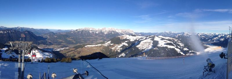 Scenic view of snow covered mountains against clear blue sky