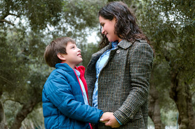 Full length of mother and daughter in forest