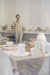 Portrait of young woman sitting on table