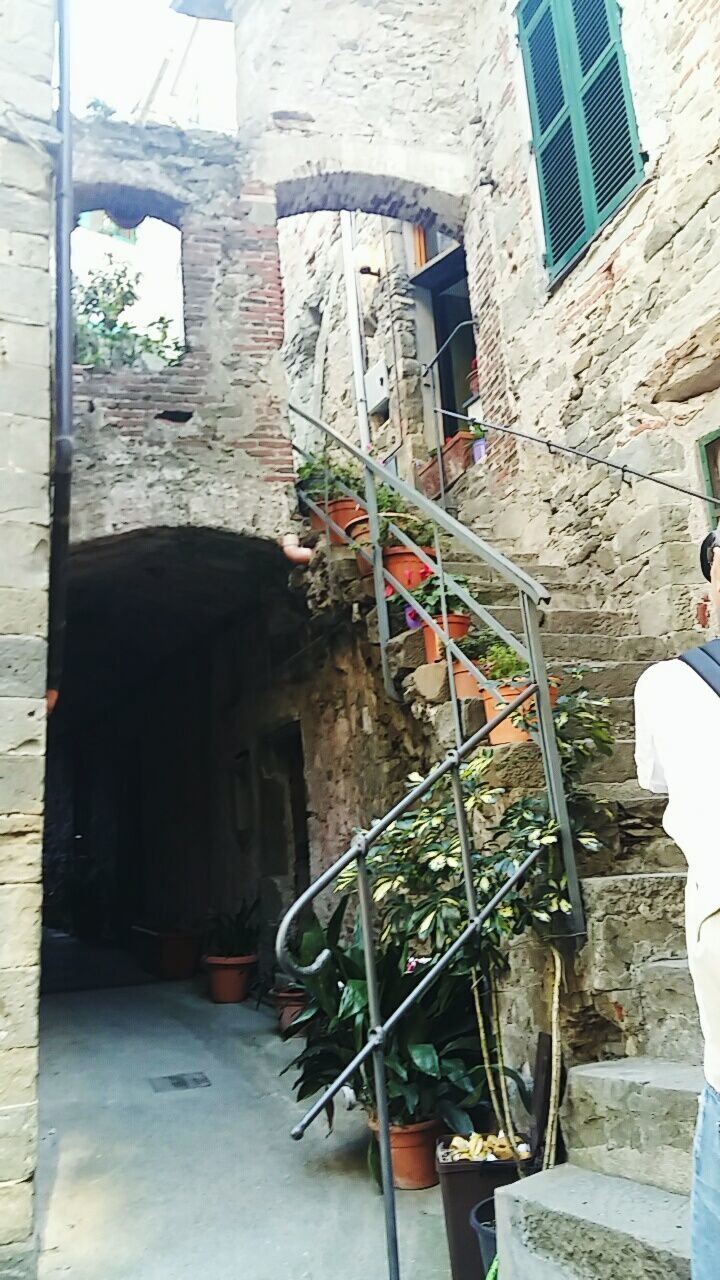 WOMAN IN FRONT OF BUILT STRUCTURES