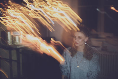 Portrait of young woman with fire