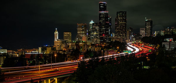 High angle view of illuminated street amidst buildings at night