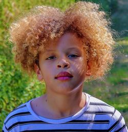 Close-up portrait of boy with frizzy hair