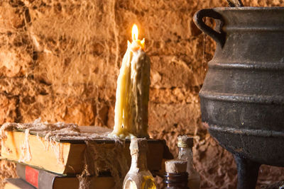 Close-up of burning candles on wood