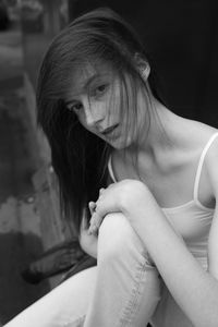 Portrait of young woman sitting outdoors