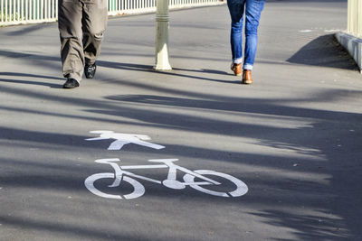 Low section of people walking on road