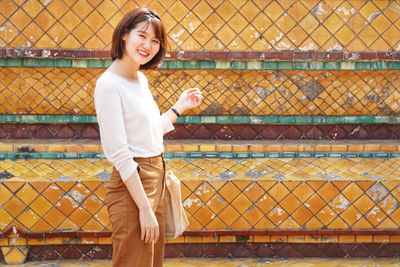 Portrait of smiling woman standing outdoors