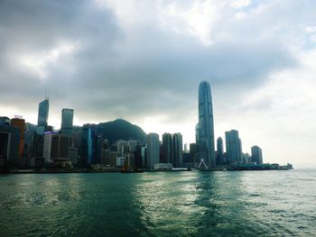 City skyline against cloudy sky