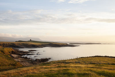 Scenic view of classiebawn castle against sky during sunset, mullaghmore, sligo. 