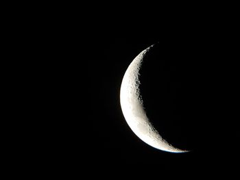 Low angle view of half moon against sky at night