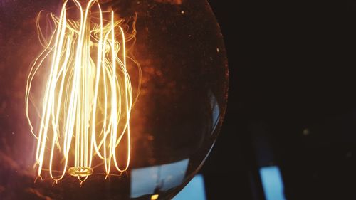 Close-up of illuminated light bulb