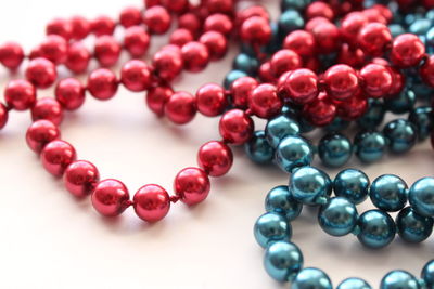 Close-up of pearl necklaces against white background