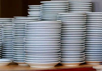 Close-up of stack of white plates