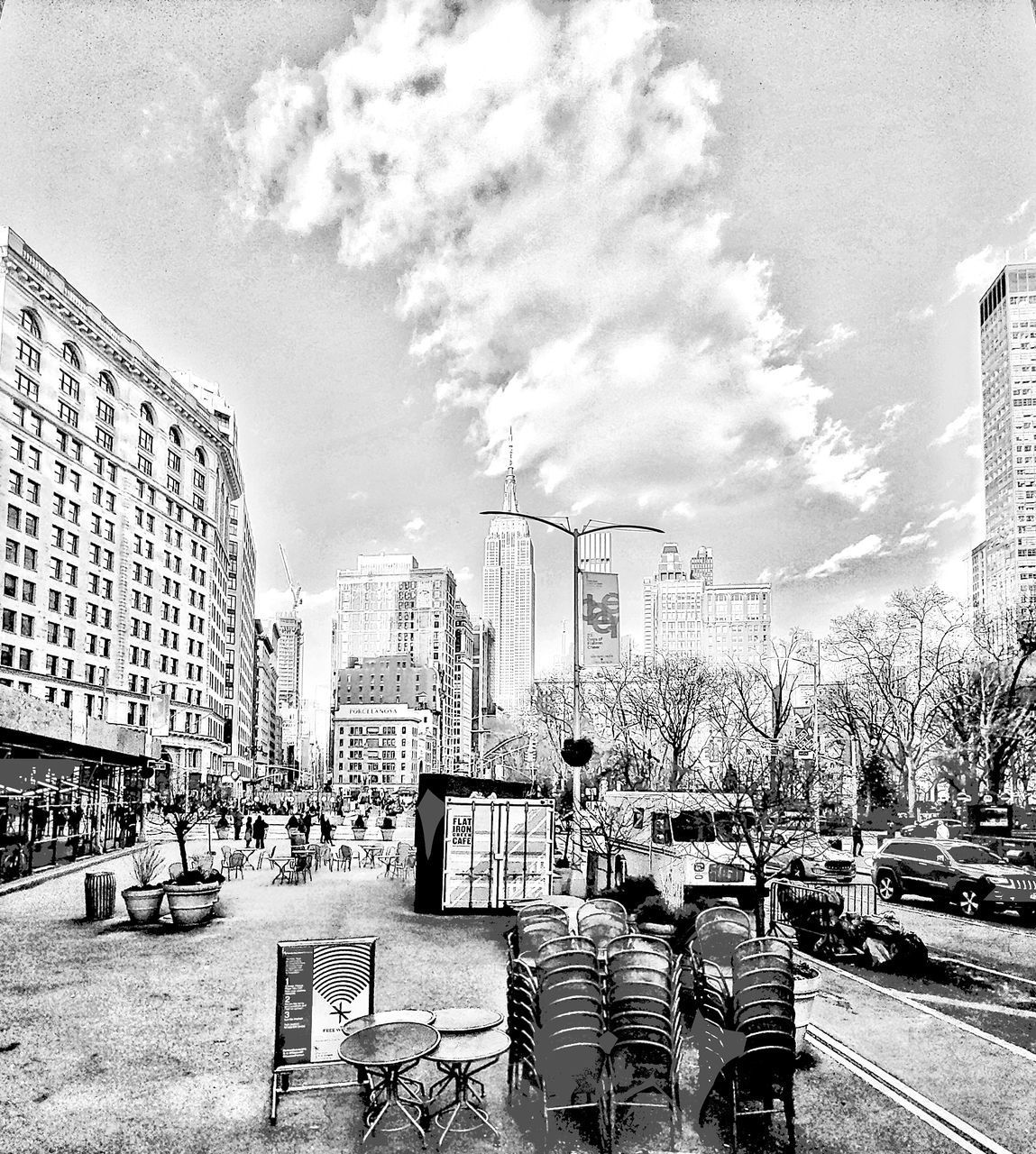 CITY STREET BY BUILDINGS AGAINST SKY