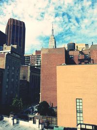 Buildings against cloudy sky