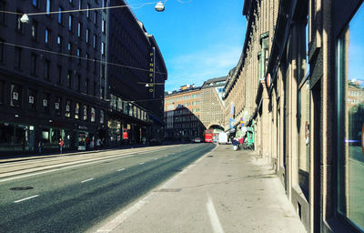 Vehicles on road along buildings