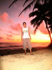 Full length of siblings at beach during sunset