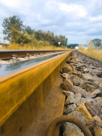 Surface level of railroad track against sky