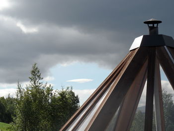 Low angle view of building against cloudy sky