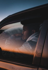 Reflection of people on car window