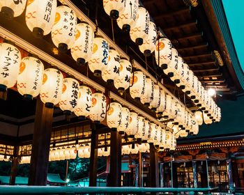 Low angle view of illuminated lanterns hanging outside building