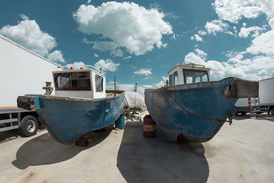 Panoramic view of ship moored on land against sky