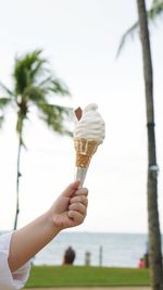 Close-up of hand holding ice cream cone