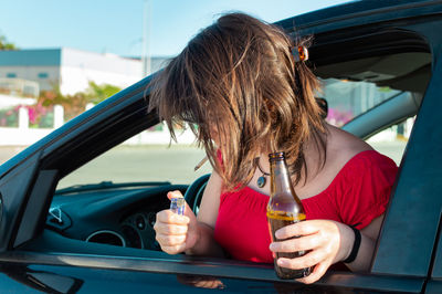 Rear view of woman sitting in car