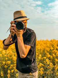 Man photographing camera on field