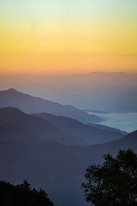 Scenic view of silhouette mountains against sky during sunset