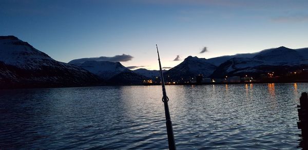 Scenic view of lake and mountains against sky during sunset