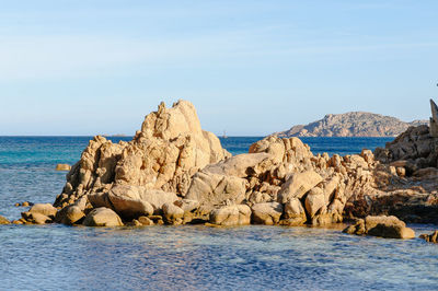 Panoramic view of rocks on beach against sky