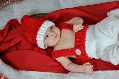 Portrait of a newborn baby in christmas clothes and santa hat