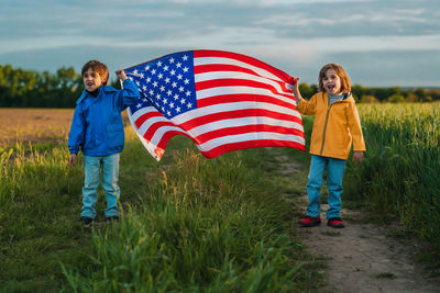 Rear view of woman holding american flag