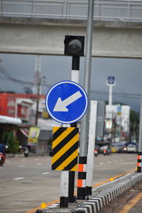 Road sign against blue sky