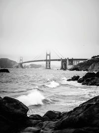 View of suspension bridge over sea