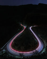 Aerial view of light trails on road at night