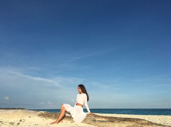 Woman on beach against sky