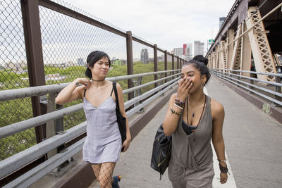 Friends walking across a bridge