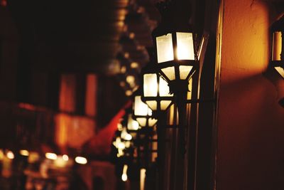 Low angle view of illuminated lamp hanging in building