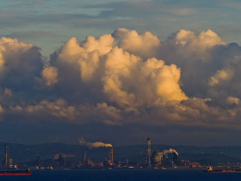 Scenic view of factory against sky during sunset