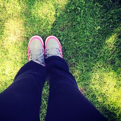 Low section of person standing on grassy field