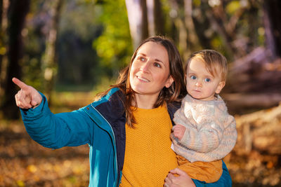 Portrait of young woman standing outdoors