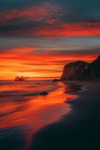 Scenic view of sea against romantic sky at sunset