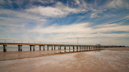 Bridge over sea against sky