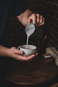 Midsection of man holding coffee