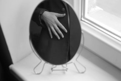 Close-up of woman hand on mirror