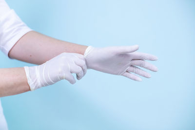 Close-up of hands over blue background